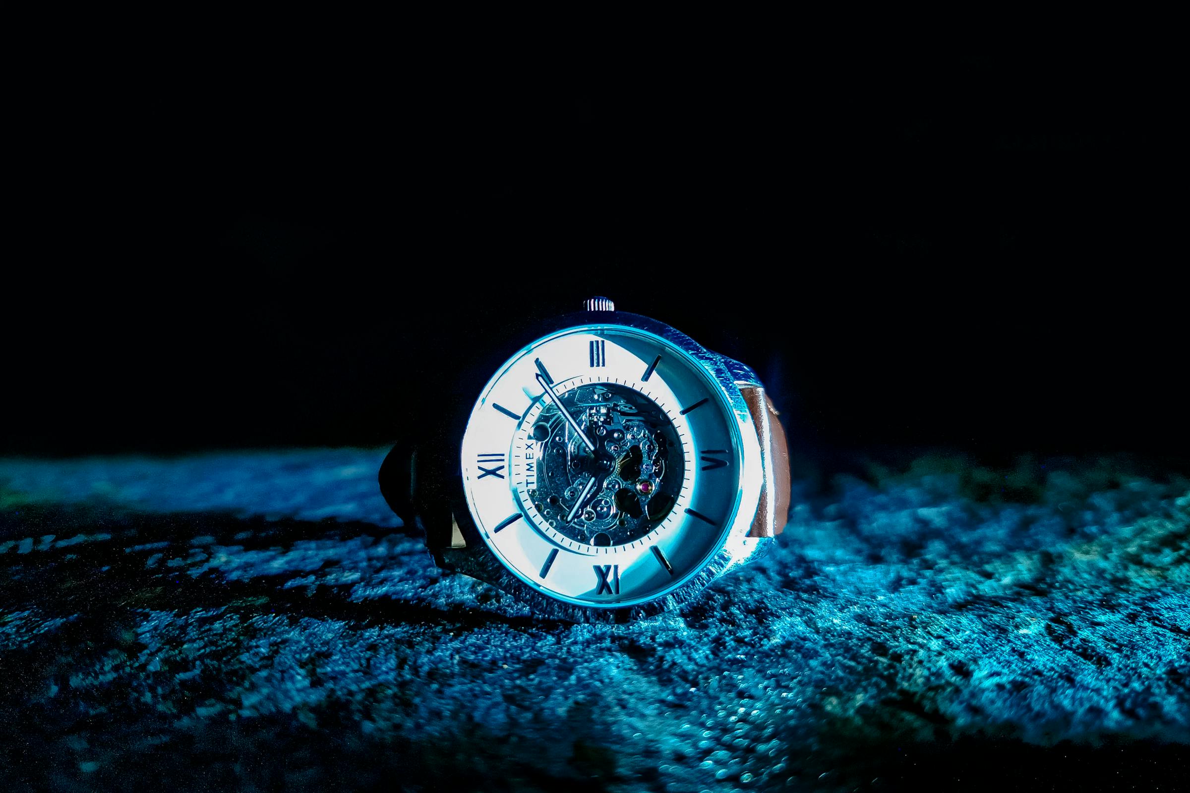 Close study of a luxury wristwatch, dial and case caught in low editorial light.